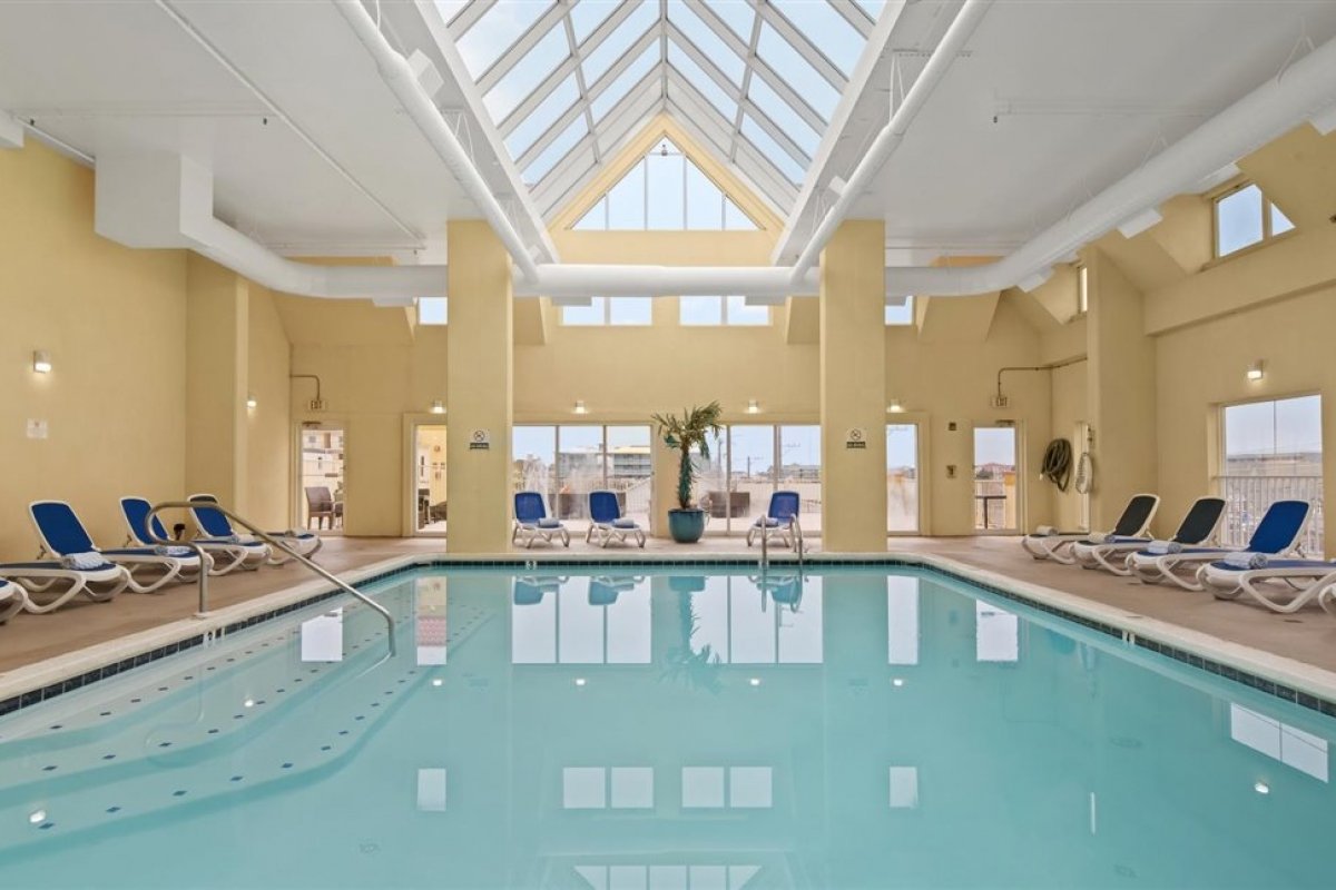a large indoor swimming pool with lounge chairs