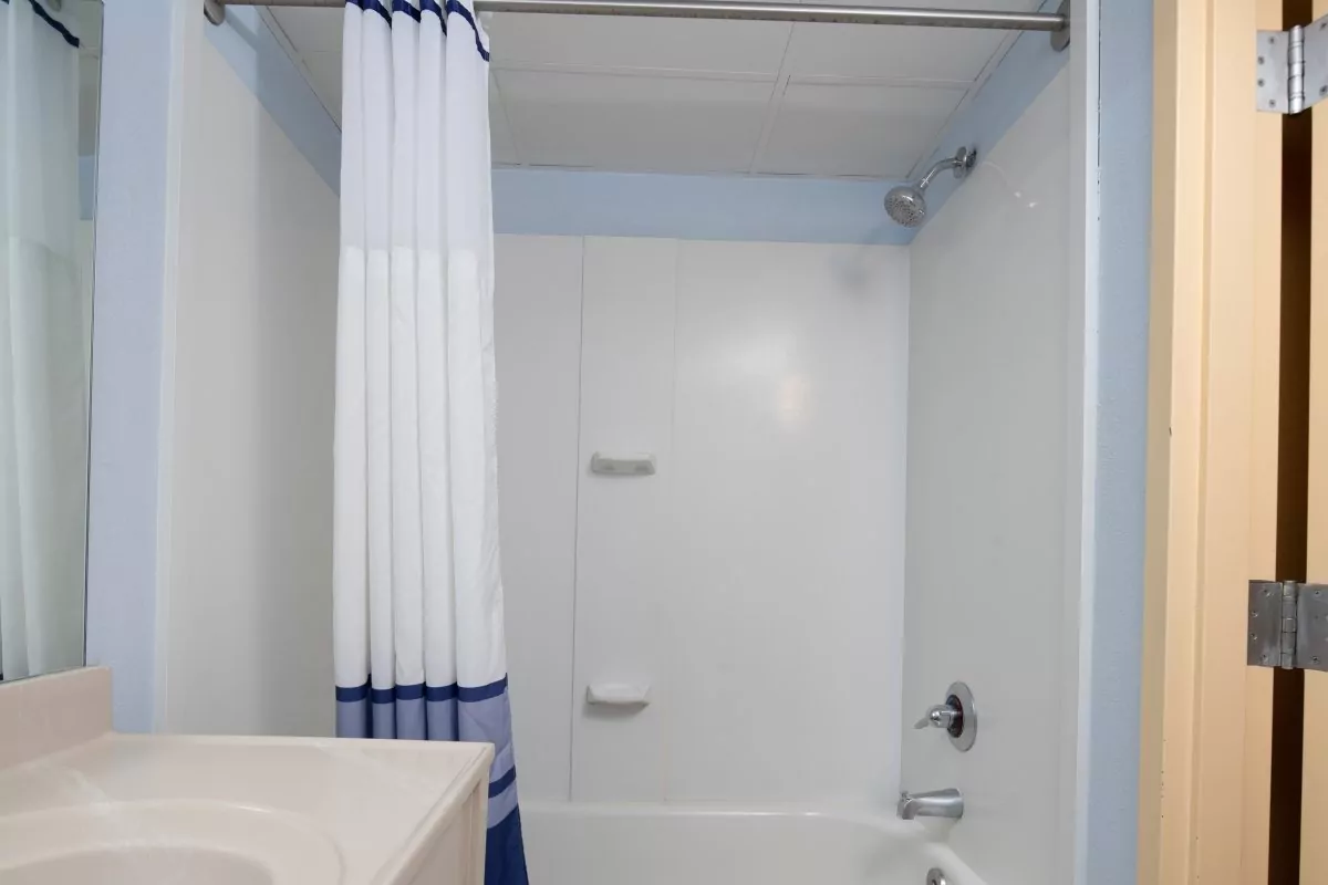 a bathroom with a shower, sink and bathtub