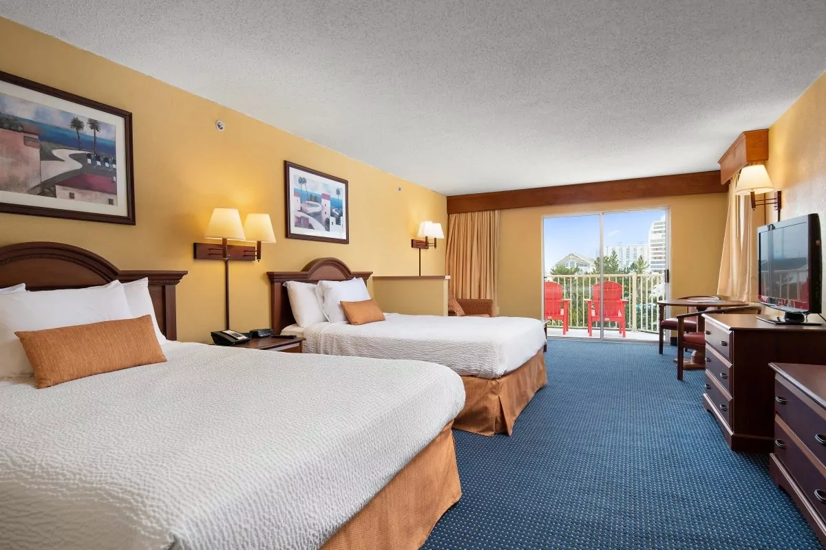 a hotel room with two beds and a television