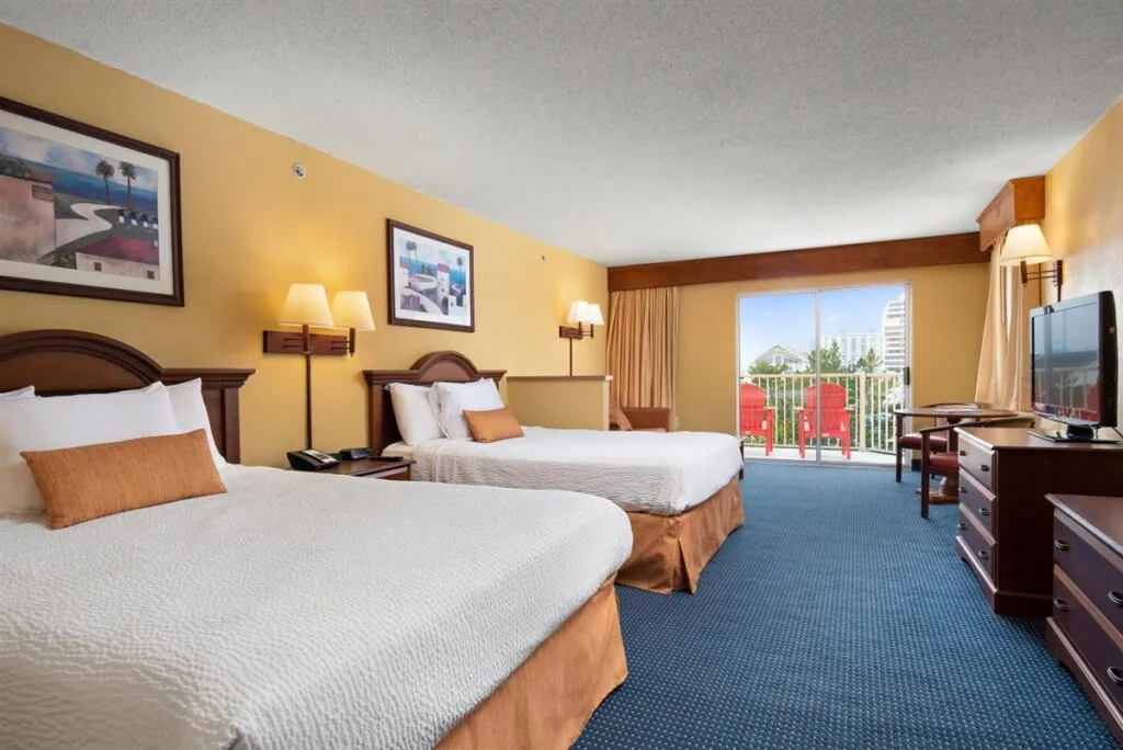 a hotel room with two beds and a television